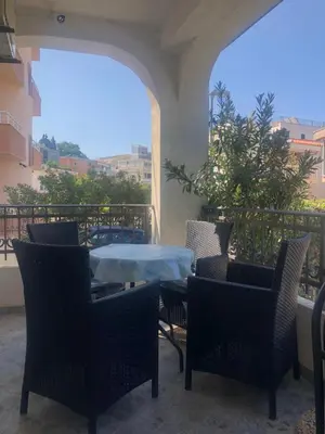 a patio with a table and chairs on a balcony at Apartmani Vedrana Sutomore in Sutomore