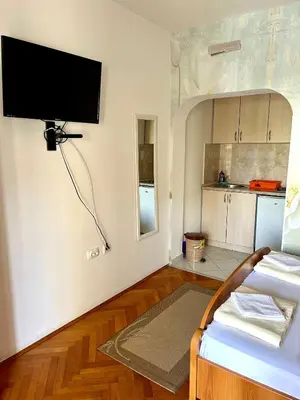 a living room with a flat screen tv on the wall at Apartmani Vedrana Sutomore in Sutomore