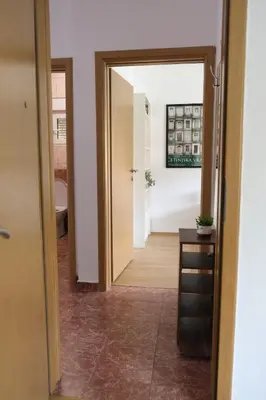 a hallway with a door leading into a room at Olivers Cozy and Spacious Apt in Podgorica