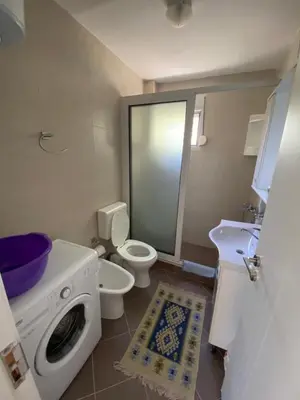 a bathroom with a washing machine and a toilet at Nana Dea 2 in Utjeha