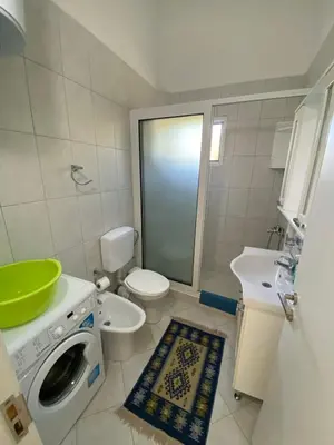 a bathroom with a washing machine and a sink at Nana Dea 2 in Utjeha