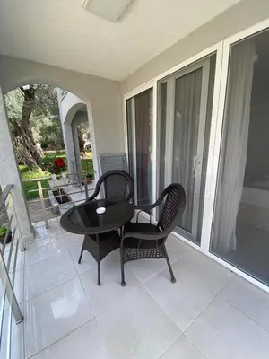 a patio with two chairs and a table on a porch at Nana Dea 2 in Utjeha