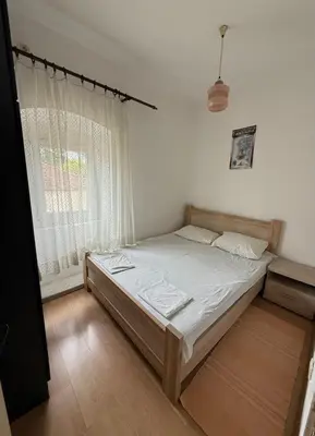 a bedroom with a bed and a window at Herceg Novi Guest house in Podgorica