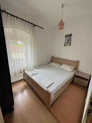 a bedroom with a bed and a window at Herceg Novi Guest house in Podgorica