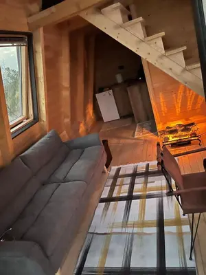 a living room with a couch and a table at Podgoricka Koliba