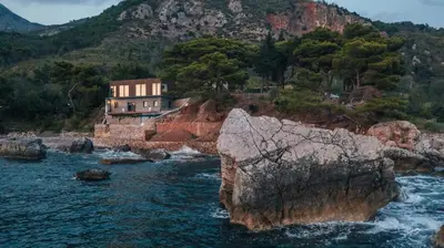 a house on the shore of a body of water at Art Residence Holiday Home in Bar