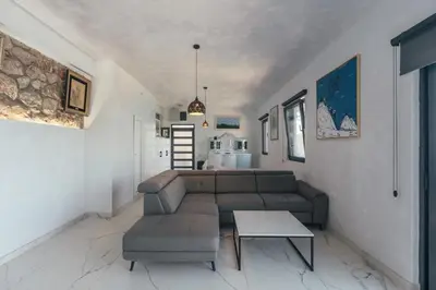 a living room with a couch and a table at Art Residence Holiday Home in Bar