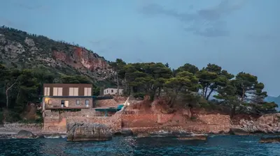 a house on a rocky island in the water at Art Residence Holiday Home in Bar