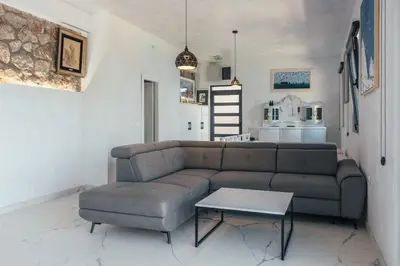 a living room with a couch and a table at Art Residence Holiday Home in Bar