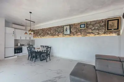 a kitchen and dining room with a table and chairs at Art Residence Holiday Home in Bar
