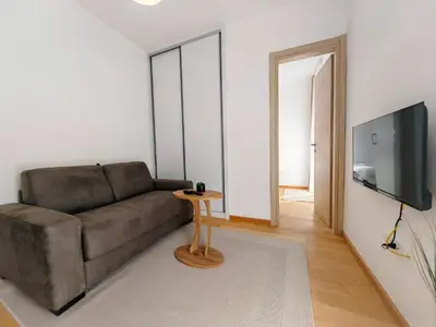 a living room with a couch and a television at Modern City Apartment Budva 2-Central Location,5 min to Beach in Kravlja