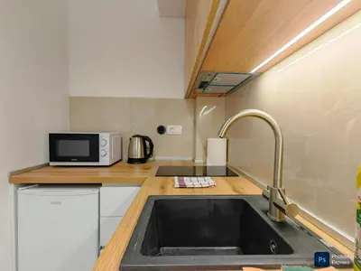 a small kitchen with a sink and a microwave at Modern City Apartment Budva 2-Central Location,5 min to Beach in Kravlja