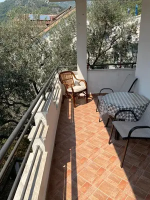 a balcony with a table and chairs on a balcony at Revea in Budva