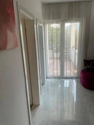 an empty living room with a sliding glass door at Revea in Budva