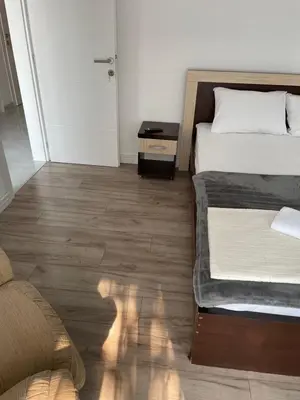 a bedroom with a bed and a wooden floor at Revea in Budva