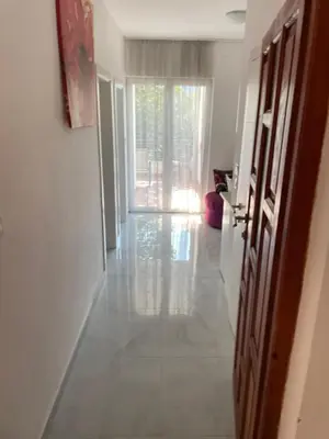 a room with a hallway with a door and a window at Revea in Budva