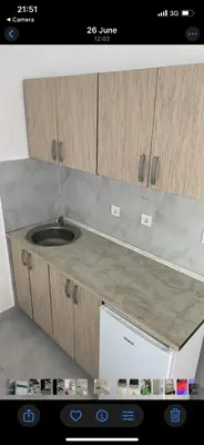 a kitchen counter with a sink on top of a stove at Revea in Budva