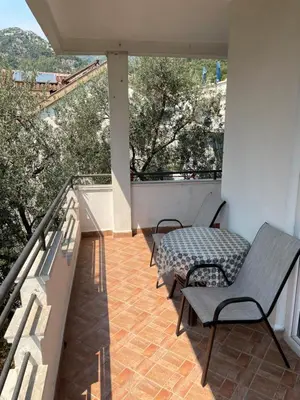a balcony with two chairs and a table on it at Revea in Budva