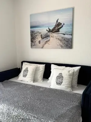 a bedroom with a bed with a picture on the wall at Cozy Studio 11 Budvablue with Pool - Parking in Budva