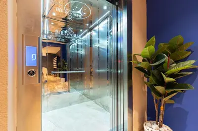 a glass elevator in a building with a potted plant at Cozy Studio 11 Budvablue with Pool - Parking in Budva