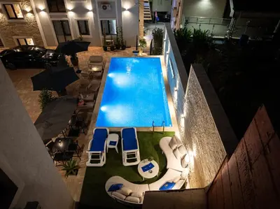 an overhead view of a swimming pool with lounge chairs at Cozy Studio 11 Budvablue with Pool - Parking in Budva