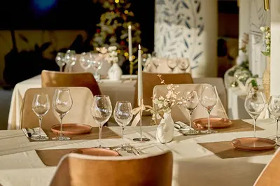 a table with wine glasses and plates on it at Skyline Sunset in Becici