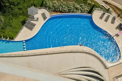 an overhead view of a swimming pool with chairs at Skyline Sunset in Becici