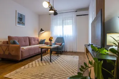 a living room with a couch and a table at Floret Suite in Podgorica
