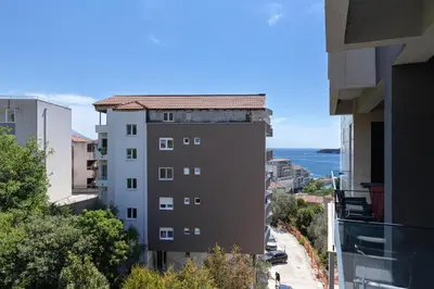 an apartment building with a view of the ocean at Aura Zafiro in Budva