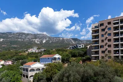 a view of a city with a mountain in the background at Aura Zafiro in Budva