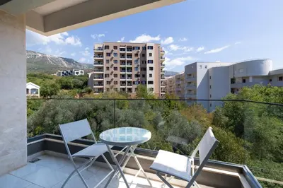 a balcony with a table and chairs on a balcony at Aura Zafiro in Budva