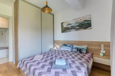 a bedroom with a bed with a purple comforter at Aura Zafiro in Budva