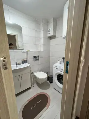 a bathroom with a toilet and a washing machine at Hedonist in Ulcinj