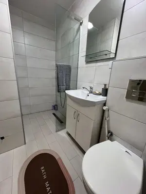 a bathroom with a toilet and a sink and a mirror at Hedonist in Ulcinj
