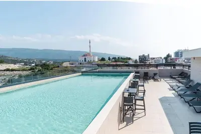 a swimming pool on the roof of a building at Hedonist in Ulcinj
