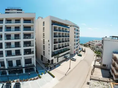 an aerial view of a street with buildings and the ocean at Hedonist in Ulcinj