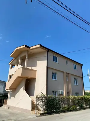 a building on the side of a street at Apartman Buki in Bjeliši