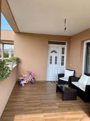 a small pink scooter sitting on the floor of a house at Apartman Buki in Bjeliši