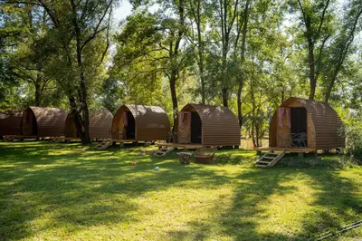 a group of four tents in the grass at Camp River Skadar Lake in Gostilj