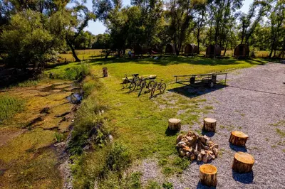 a group of benches and logs in a park at Camp River Skadar Lake in Gostilj