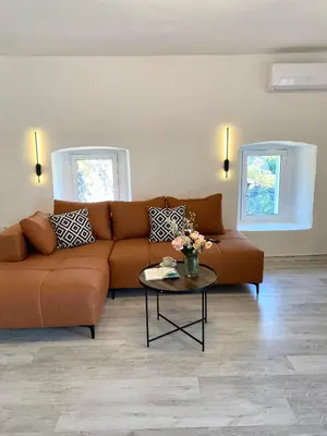 a living room with a couch and a table at Stone house Kana-Skadar Lake in Dodoši