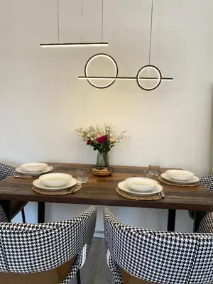 a table with chairs and plates and a vase of flowers at Stone house Kana-Skadar Lake in Dodoši
