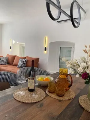a living room with a table with two wine glasses at Stone house Kana-Skadar Lake in Dodoši