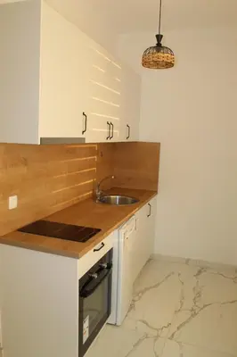 a kitchen with a sink and a counter top at Lunis Dobra Voda in Dobra Voda
