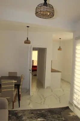 a dining room and living room with a table at Lunis Dobra Voda in Dobra Voda
