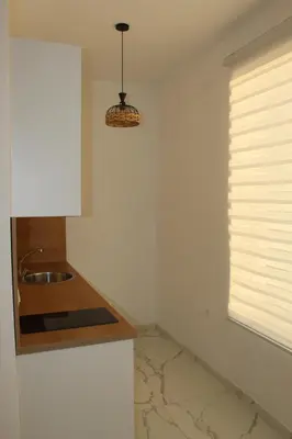 a kitchen with a sink and a window at Lunis Dobra Voda in Dobra Voda