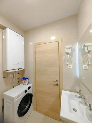 a bathroom with a washing machine and a sink at Modern City Apartment Budva3-Central Location,5 min to Beach in Kravlja