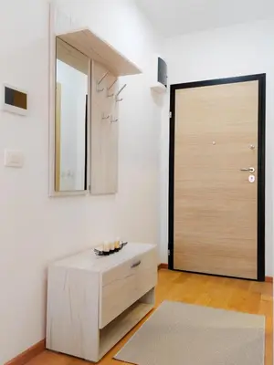 a room with a door and a table and a mirror at Modern City Apartment Budva3-Central Location,5 min to Beach in Kravlja