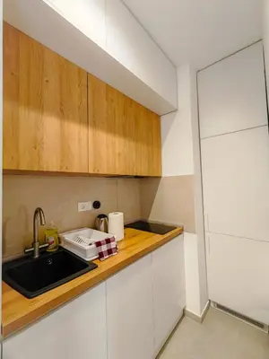 a kitchen with white cabinets and a sink at Modern City Apartment Budva3-Central Location,5 min to Beach in Kravlja