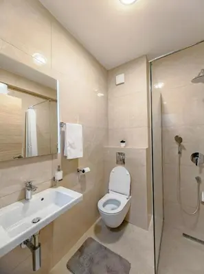 a bathroom with a toilet and a sink and a shower at Modern City Apartment Budva3-Central Location,5 min to Beach in Kravlja